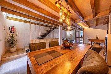 A fire extinguisher is hanging from the ceiling above a wooden table