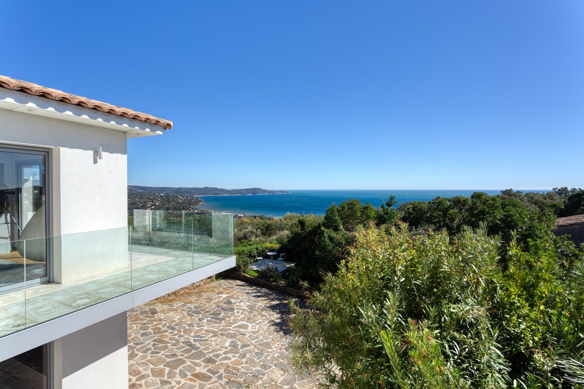 A view of the ocean from the balcony of a house