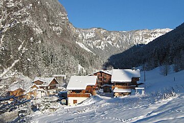 A snowy landscape with a mountain in the background