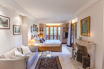 A bedroom with a fireplace and a couch