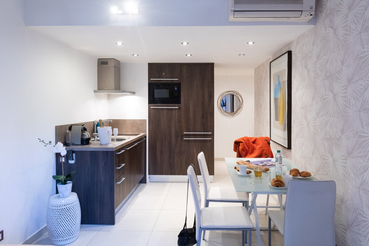 A kitchen with a table and chairs and a picture on the wall