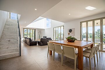 A living room with a dining table and chairs