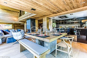 A dining room table with plates and glasses on it