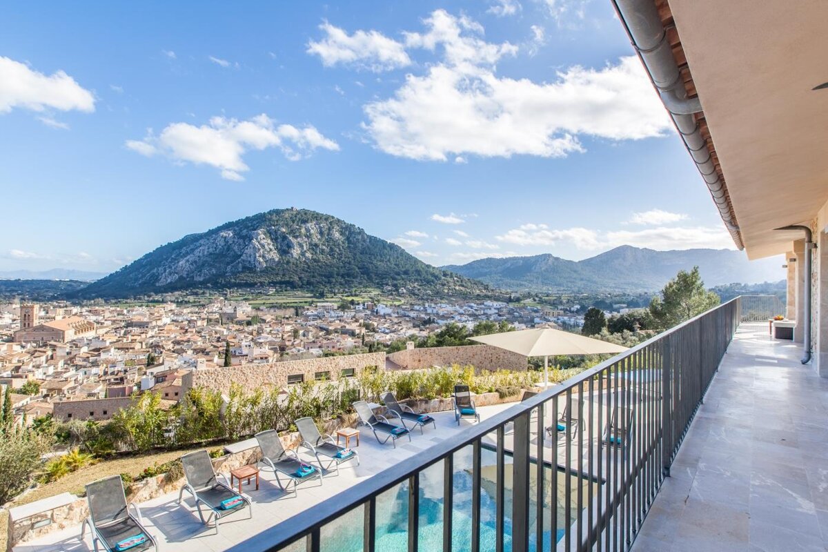 A balcony overlooking a city with a mountain in the background