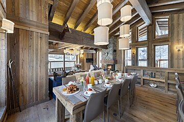 A dining room table with plates of food on it