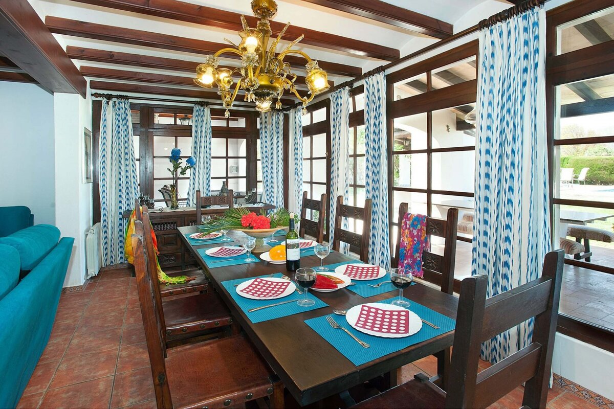 A dining room table with plates and glasses on it