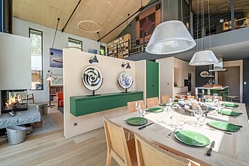 A dining room table with plates and glasses on it