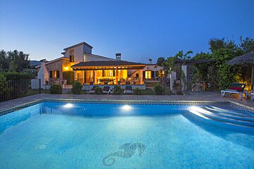 A house with a swimming pool in front of it