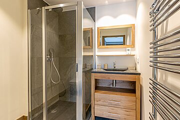 A bathroom with two sinks and a towel rack