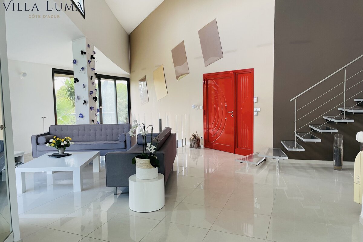 A living room with a red door that says villa luma