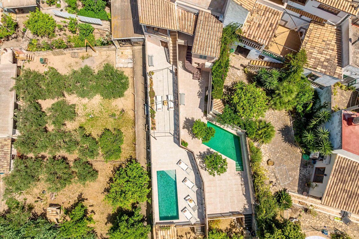 An aerial view of a house with a swimming pool