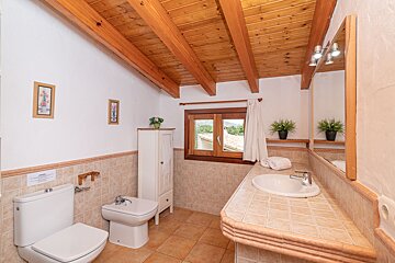 A bathroom with a toilet a bidet and a sink