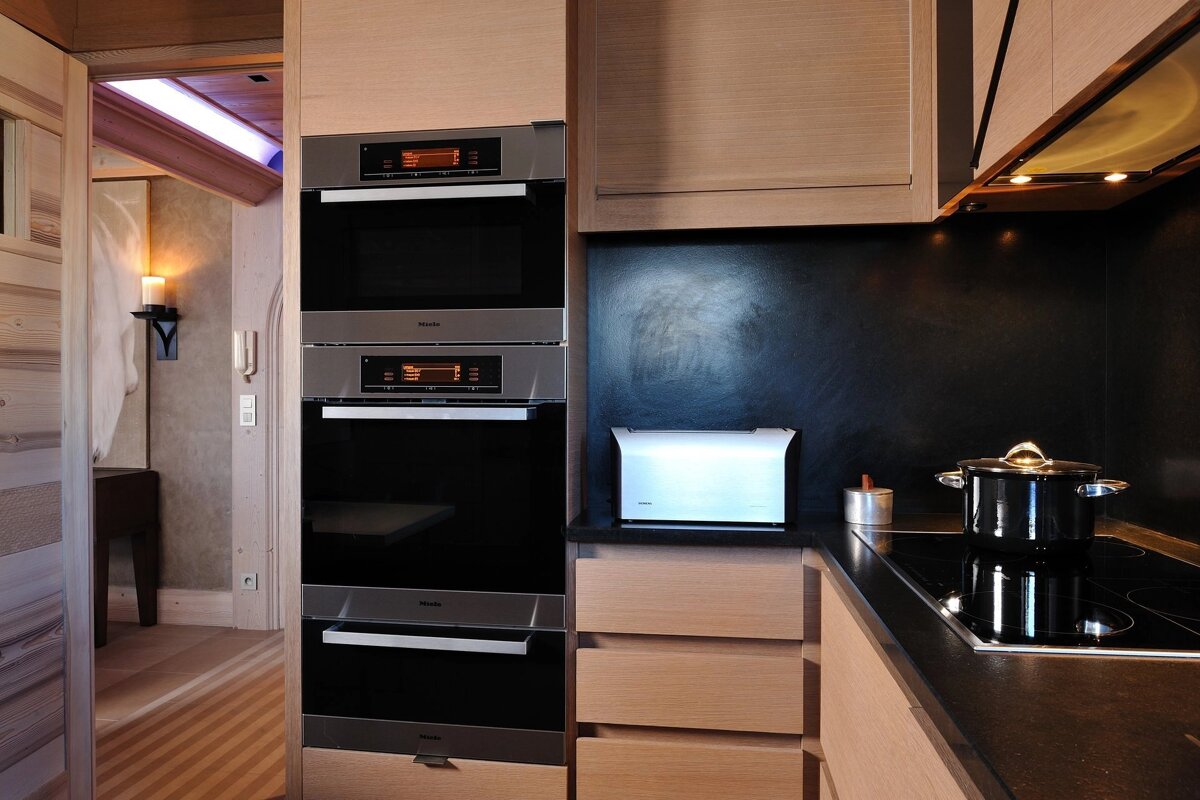 A kitchen with a stove top oven and a toaster oven