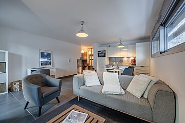 A living room with a couch and two chairs