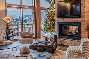 A living room with a fireplace and a christmas tree