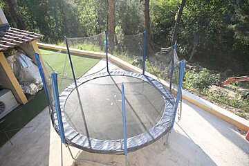 A round trampoline with a blue net around it