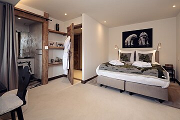 A bedroom with a bed and a picture of polar bears on the wall