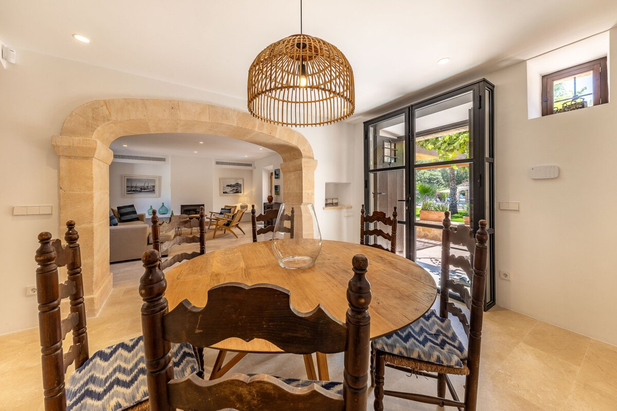 A dining room with a wooden table and chairs