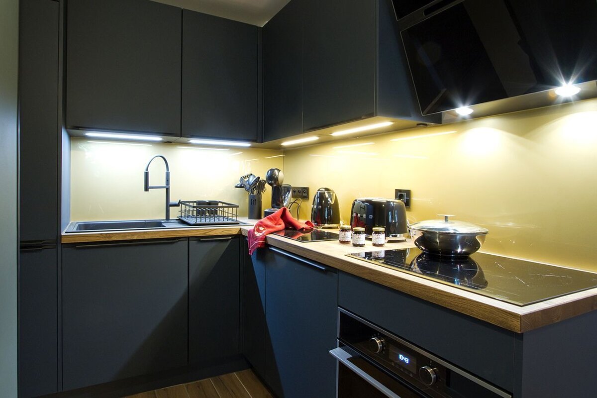 A kitchen with black cabinets and a smeg toaster