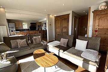 A living room with a couch and two tables