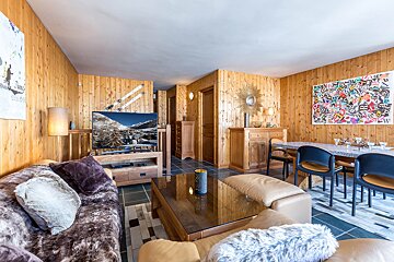 A living room with a couch and a flat screen tv