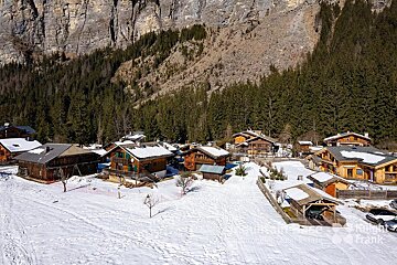 An aerial view of a snowy village taken by frank