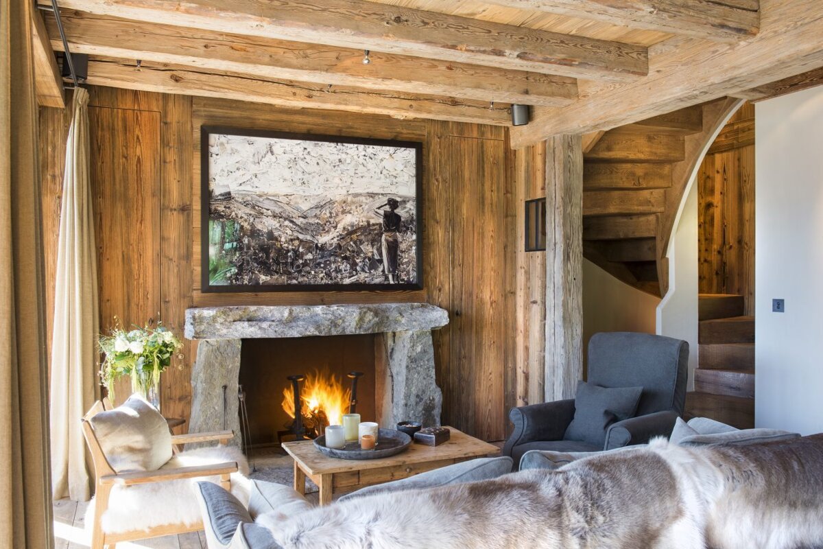 A living room with a fireplace and a painting on the wall