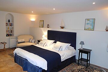 A bedroom with a king size bed and pillows that say 