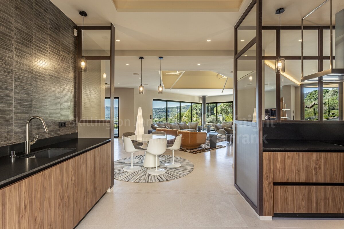 A kitchen with a dining table and chairs and a sink