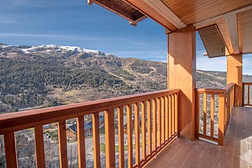A balcony with a view of a mountain range