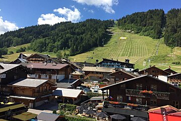 A ski lift is going up a hill in the background