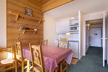 A room with a table and chairs and a sign on the wall that says ' a ' on it