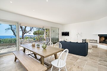 A living room with a table and chairs and the word jansons on the wall