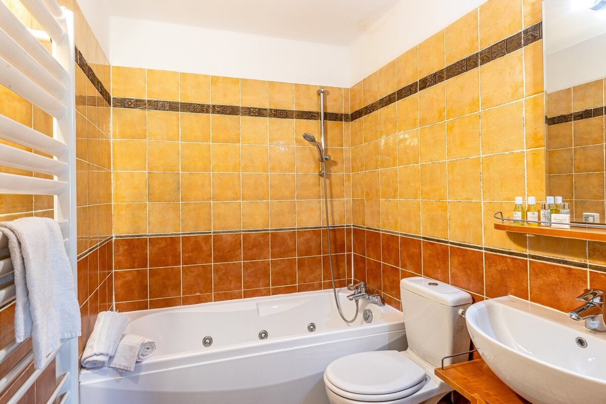 A bathroom with a bathtub toilet and sink