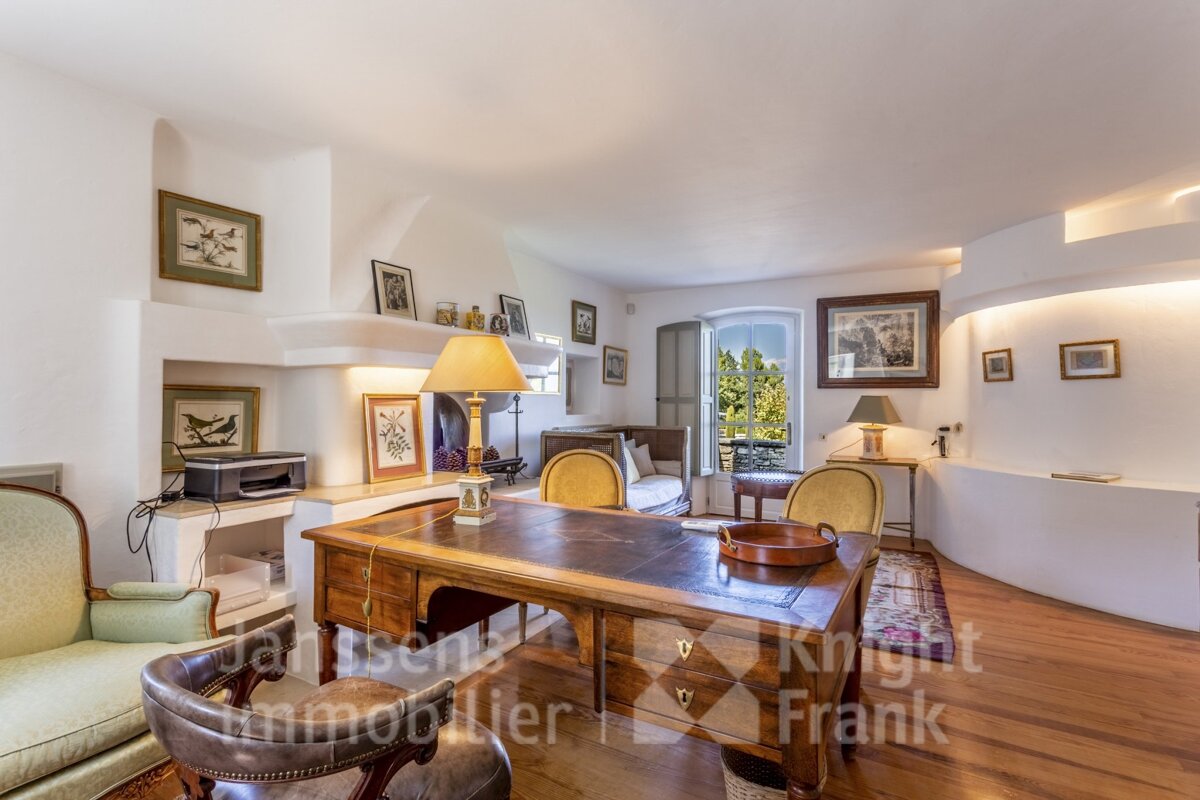 A living room with a desk and chairs and a sign that says knight frank
