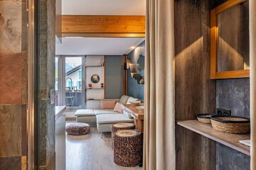 A living room with a couch and a mirror