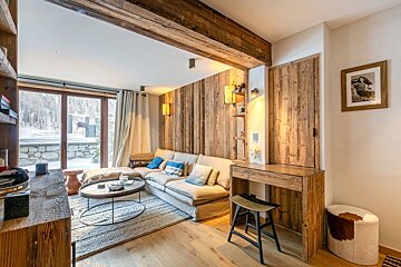 A living room with a couch and a table and a picture on the wall that says east coast