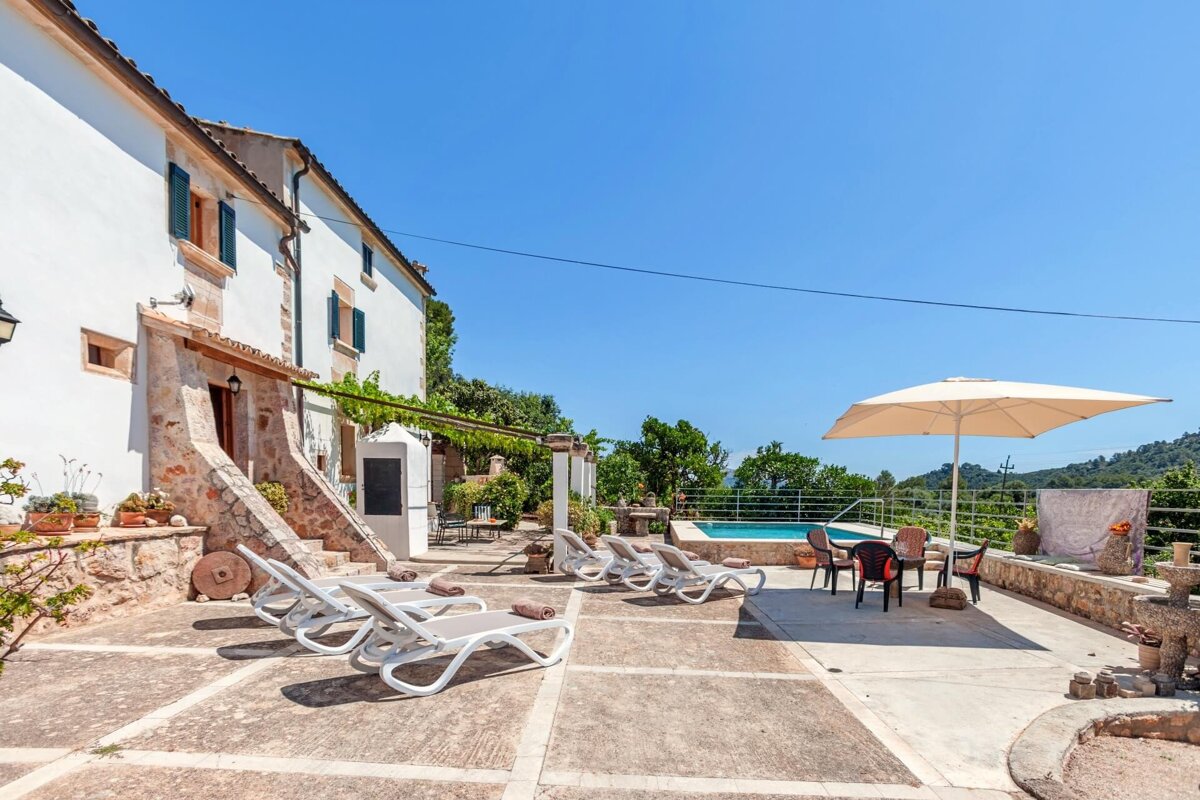 A large white house with a swimming pool in front of it