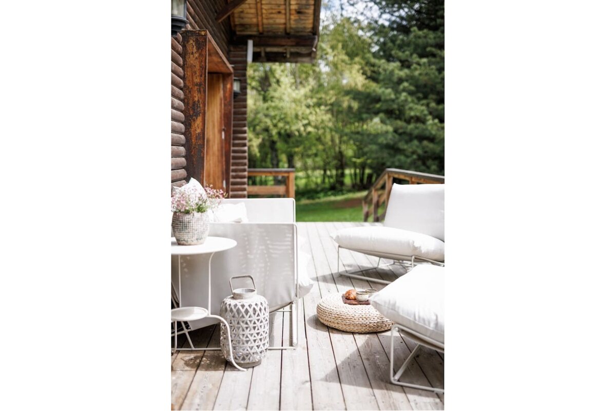 A wooden deck with a table and chairs on it