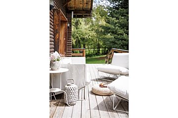 A wooden deck with a table and chairs on it
