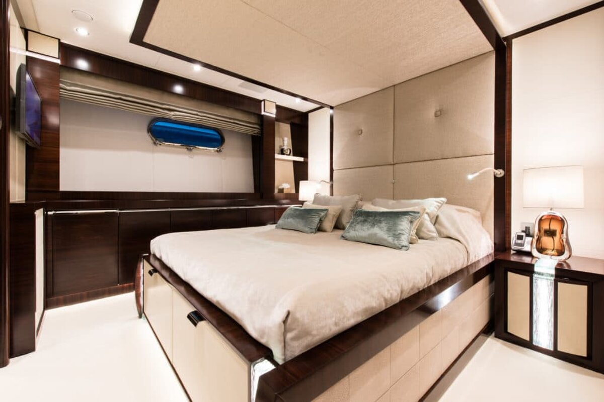 A bedroom with a large bed and a window