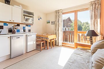 A kitchen with a table and chairs and a lamp