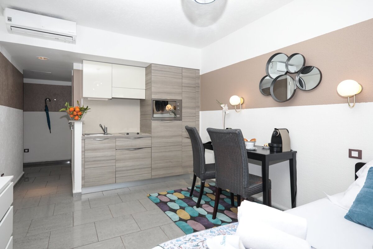 A small room with a desk and chairs and a microwave