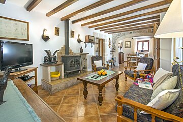 A living room with a fireplace and a flat screen tv