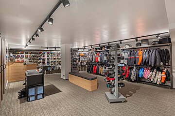 The inside of a store with clothes and helmets on display