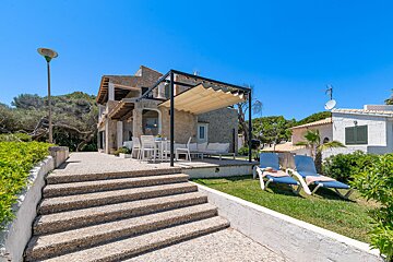 Stairs leading up to a house with a canopy over it