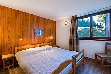 A bedroom with a bed and a picture on the wall