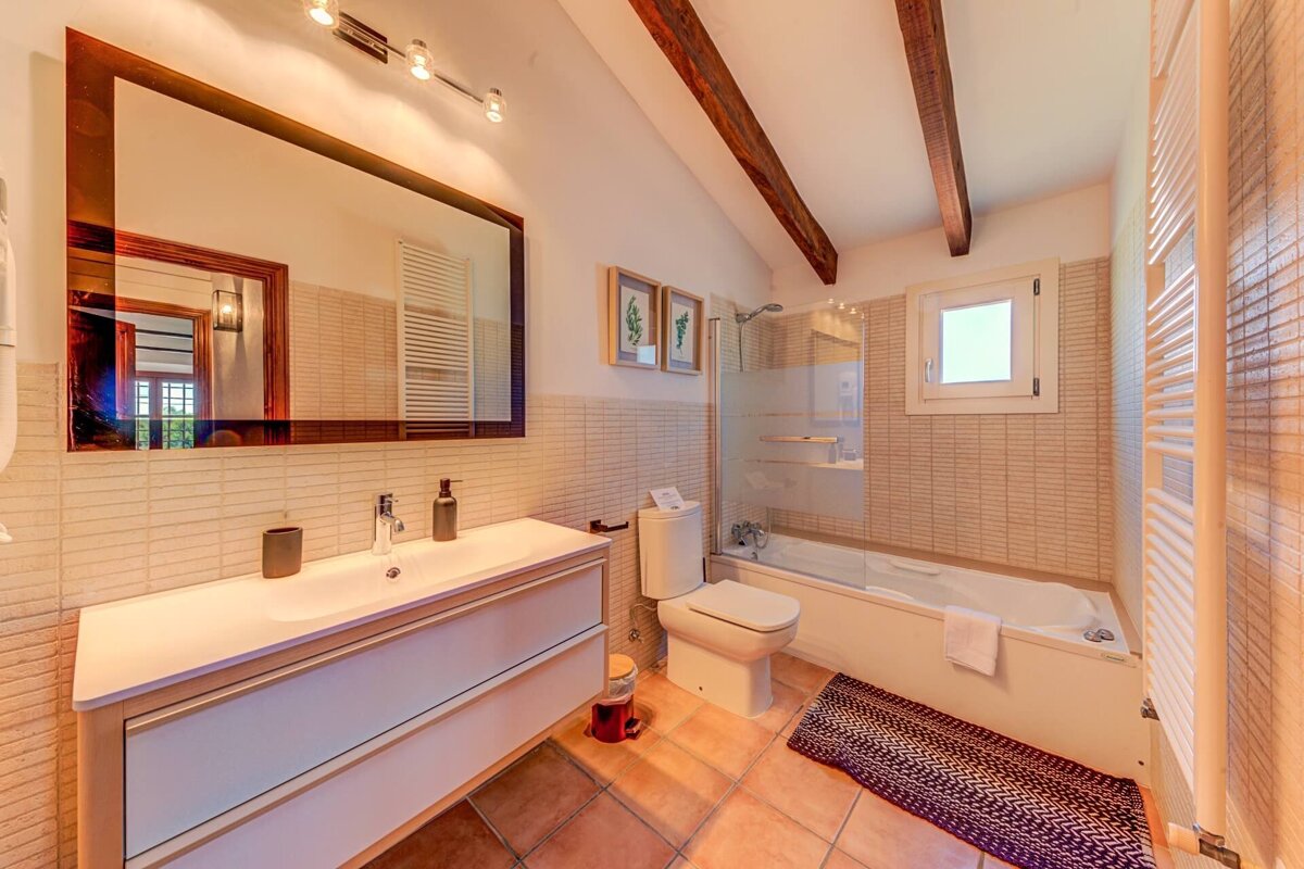 A bathroom with a toilet a sink and a bathtub