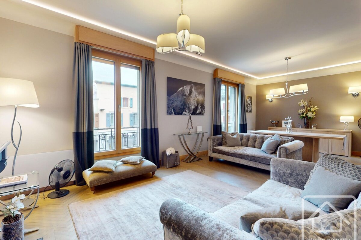 A living room with a couch and a picture of a horse on the wall