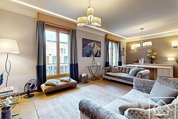 A living room with a couch and a picture of a horse on the wall